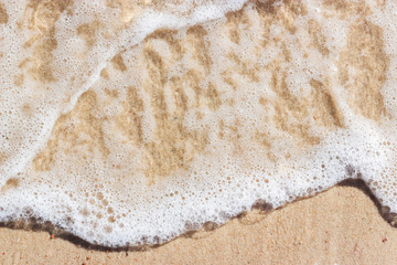 Soft wave on sandy beach. Background.