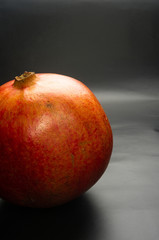 Pomegranate on black background