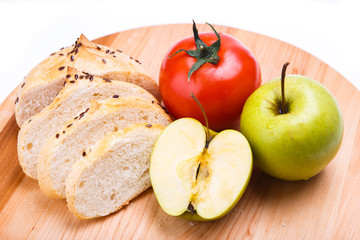 white bread with beans, tomato, Apple on a wooden tray