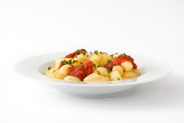 Gnocchi with tomato sauce isolated on white background.
