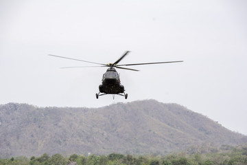 Fototapeta na wymiar Helicopter in flight. Fly over the mountain and sky