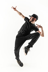 The silhouette of one hip hop male break dancer dancing on white background