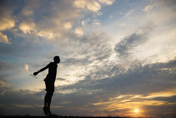 Silhouette of a man with  man exercising in the sunset.