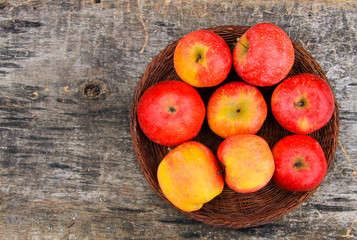 Red apples on wooden background