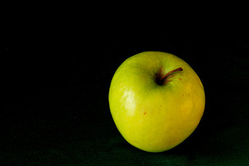 Green apple on a dark background