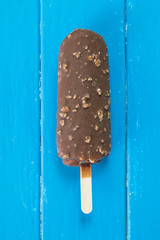Chocolate Popsicle in Blue Wood Background