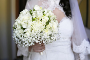 Composizione floreale tenuta in mano da una sposa