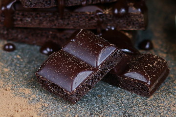 Dark porous chocolate on a dark background. Low key