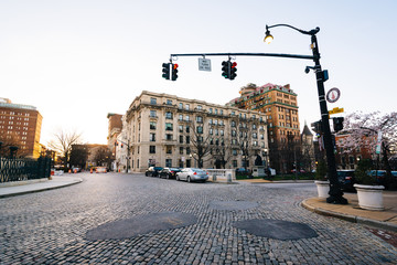 Cobblestone traffic circle and historic buildings in Mount Vernon, Baltimore, Maryland.