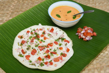 South Indian breakfast Oothappam / Dosa cooked using rice lentil and vegetables served with coconut...