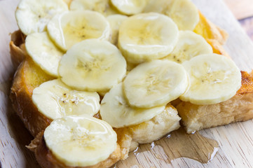 toast banana with honey caramal on table wood