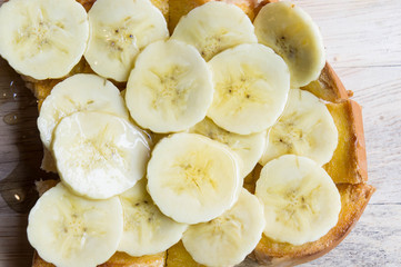 toast banana with honey caramal on table wood