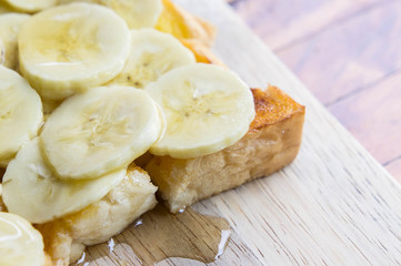 toast banana with honey caramal on table wood