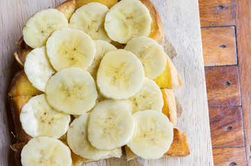 toast banana with honey caramal on table wood