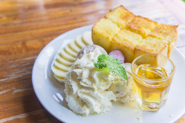ice cream honey toast and whipped cream on the table