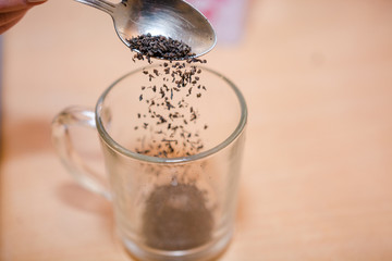 Fill tea in a bowl. Tea preparation.