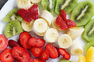 Fruits of strawberry banana kiwi and orange for breakfast on white background