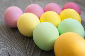 Colored painted eggs on a gray background. Easter celebrating