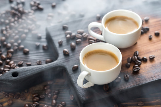 Two Cups Of Coffee With Coffee Beans