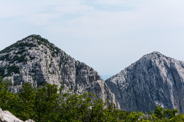 Fototapeta na wymiar High peaks, ridges and forests on hillsides in mountains of Paklenica national park, Croatia