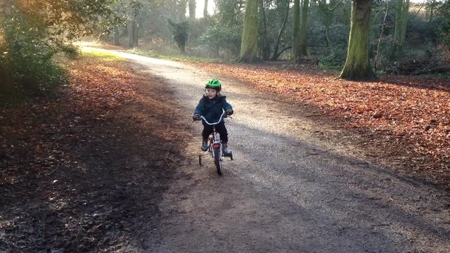 Young boy learning to ride a bike