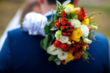 Beauty wedding bouquet in bride's hands, close - up