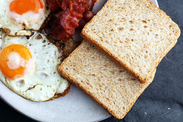 Ham and Egg. Bacon and Egg. Salted egg and sprinkled with black pepper. English breakfast.