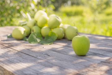 green apples on wooden background outdoor