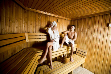 Fototapeta na wymiar Young couple relaxing in sauna