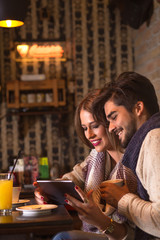 Beautiful young couple in cafe drinking coffee.