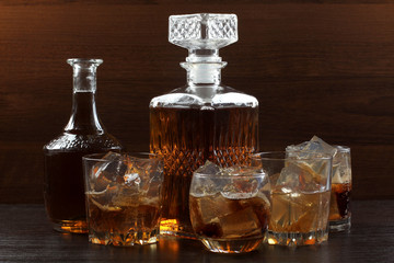 Glass and bottle whiskey on wooden table
