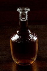 Glass and bottle whiskey on wooden table