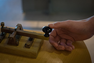 The old and vintage telegraph key and operator's hand , Morse system