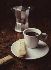 Cup of hot espresso, moka pot and cookies