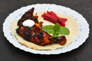 Arabian grilled chicken also called Al Faham or Alfaham or Djaj , koboos and salad very popular recipe in Middle East. made using mix Bezar spices and barbeque in a charcoal grill or in oven.