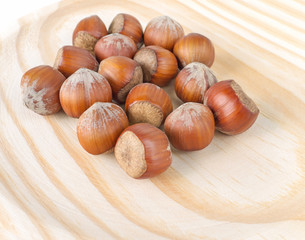 Hazelnuts on the wooden background