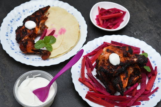 Arabian grilled chicken also called Al Faham or Alfaham or Djaj , koboos and salad very popular recipe in Middle East. made using mix Bezar spices and barbeque in a charcoal grill or in oven.