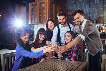 Fototapeta premium Group of friends are celebrating having fun chatting with glasses of wine at a bar restaurant.