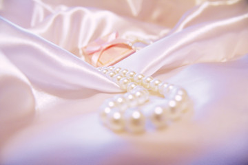 Box for jewelry and pearls on white silk. Gift. Gentle photo. Wedding.
