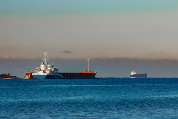 Blue cargo ship leaving Riga and entering Baltic sea
