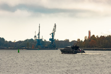 Black elite speed motor boat entering Riga