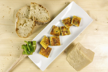 Omelette with peppers on wood background - top view
