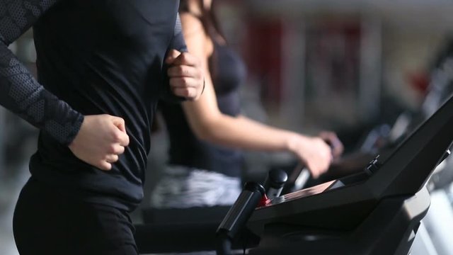 Guy and girl on the treadmill