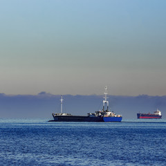 Blue cargo ship leaving Riga and entering Baltic sea