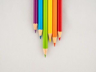 Brightly colored pencils on a white background