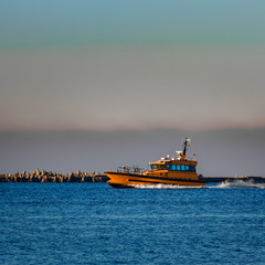 Fototapeta premium Orange pilot ship sailing from the Baltic sea in Latvia