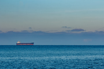 Cargo ship anchored far in the Baltic sea. Europe