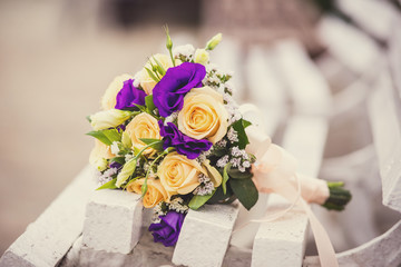 Wedding bouquet of roses on a bench