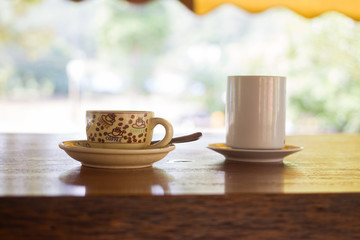 coffee cup on wooden table in nature background