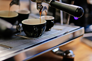 Fototapeta na wymiar Close up of professional coffee machine making cappuccino and espresso in a cafe.